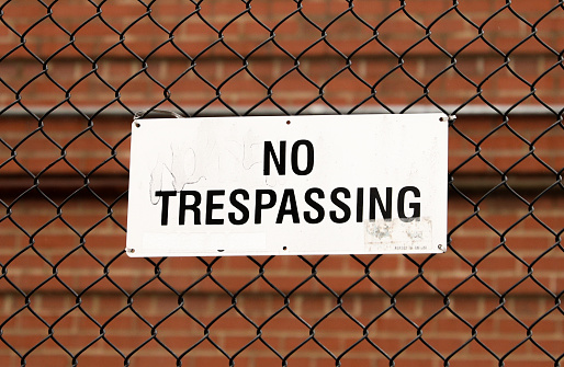 No Trespass sign in front of private property depicting security, privacy, and protection
