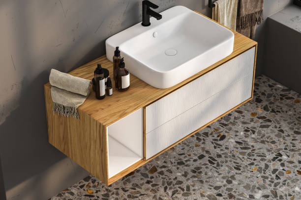 istock Realistic 3D render close up elegant bathroom vanity countertop with white ceramic wash basin and faucet. Blank space for beauty product display, terrazzo floor tiles. 1471974050