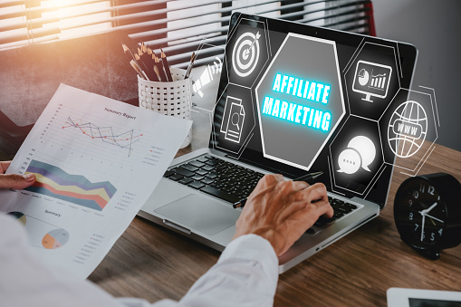 Affiliate marketing concept, Business person analyzing financial data on laptop computer with affiliate marketing icon on virtual screen, Digital Marketing content planning advertising strategy.