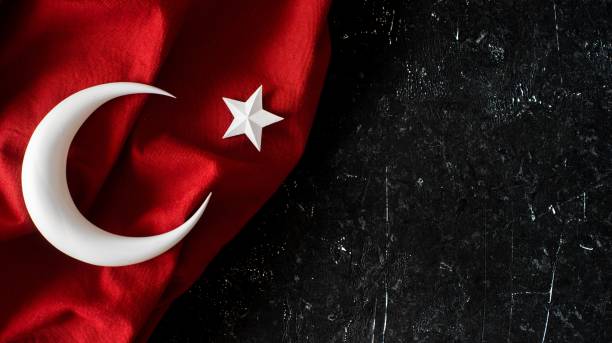 Turkish flag and 3d crescent moonand star on black stone background