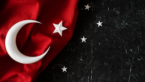 istock Turkish flag and 3d crescent moonand star on black stone background 1471977083