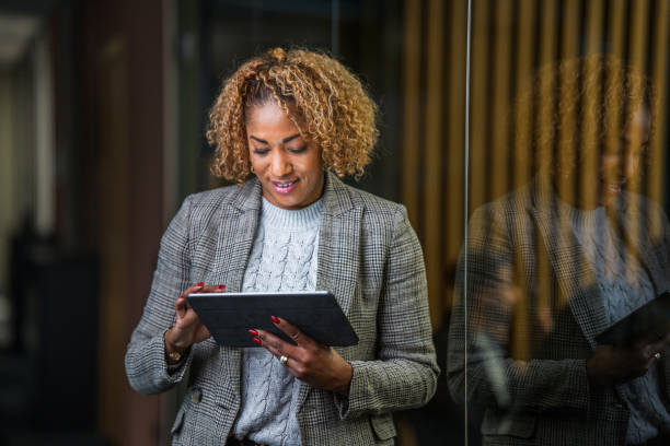 istock Hispanic Business Woman in 40s Using a Digital Tablet 1471978825