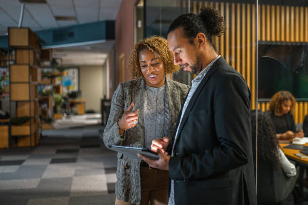 istock Hispanic Mid Adult Business Associates Using a Digital Tablet 1471978826