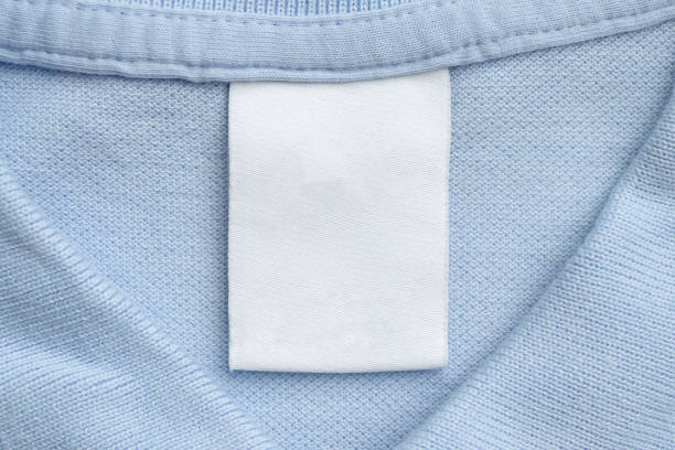 istock White blank laundry care clothes label on blue shirt fabric background 1471978867
