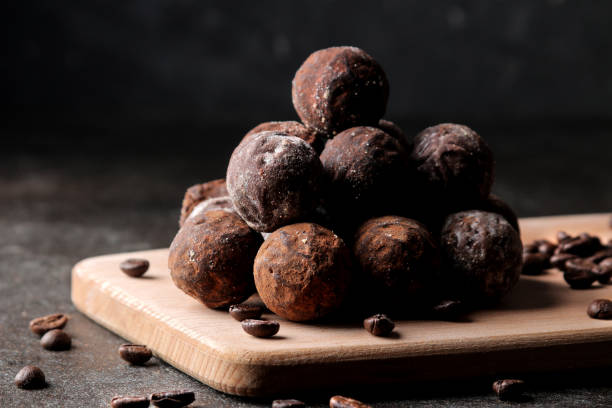 istock assorted chocolates. candy balls of different types of chocolate on a dark background. cocoa and coffee beans 1471979088