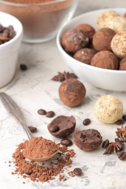 istock assorted chocolates. Candy balls of different types of chocolate on a light concrete background. cocoa, star anise and coffee beans 1471979121