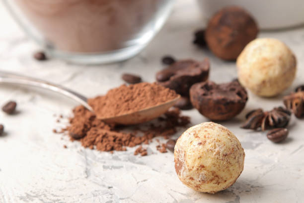 istock assorted chocolates. Candy balls of different types of chocolate on a light concrete background. cocoa, star anise and coffee beans 1471979146