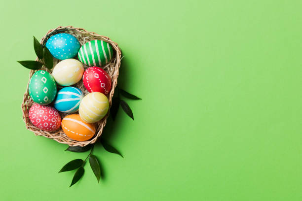 istock Multi colors Easter eggs in the woven basket on colored background . Pastel color Easter eggs. holiday concept with copy space 1471989921