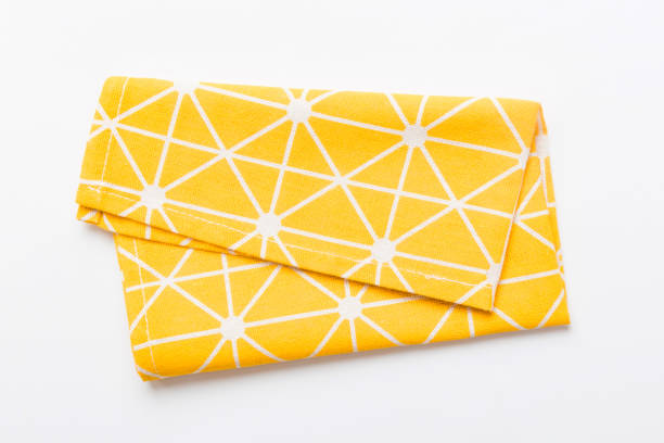 istock top view with yellow empty kitchen napkin isolated on table background. Folded cloth for mockup with copy space, Flat lay. Minimal style 1471990004