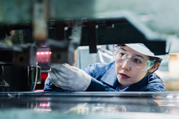 istock A female technician maintaining and inspecting machinery 1471990728
