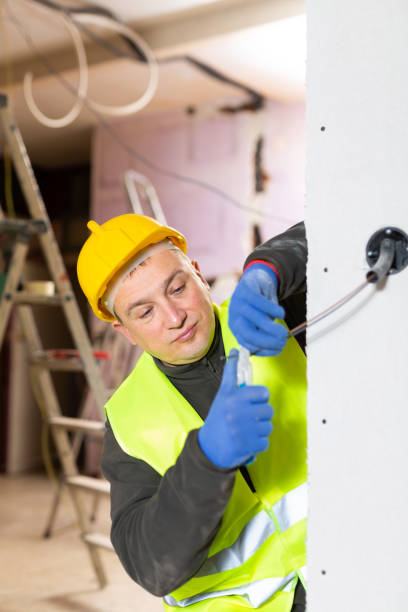 istock Experienced electrician laying electric wires in building under construction 1471990765