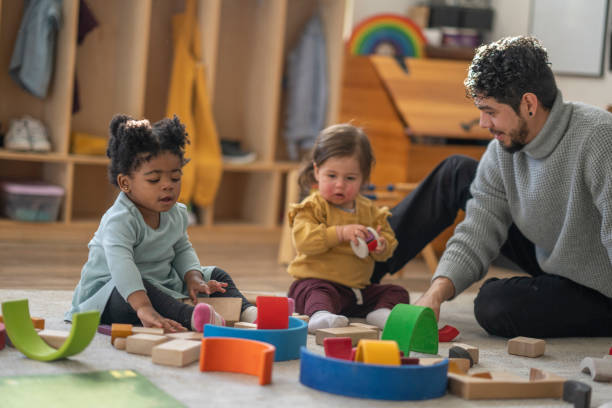 istock Male Daycare Educator with Children 1471991757