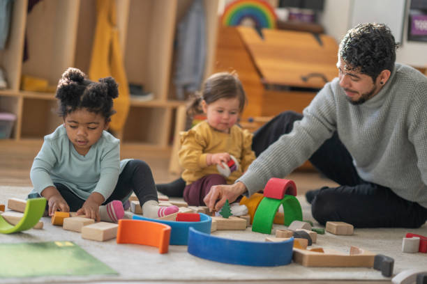 istock Male Daycare Educator with Children 1471991758
