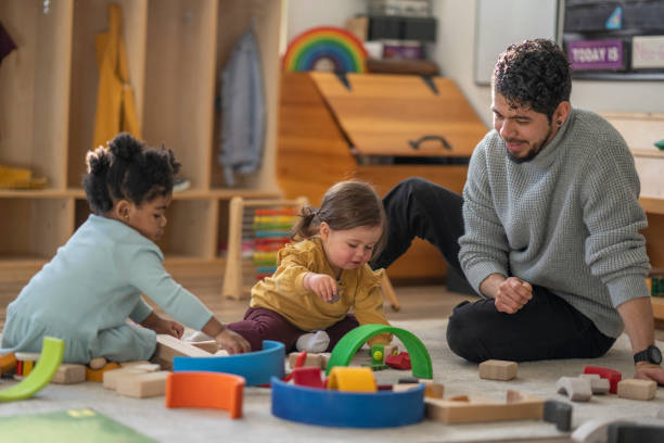istock Male Daycare Educator with Children 1471991759