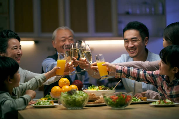 istock three generation asian family toasting while having dinner together 1471999039
