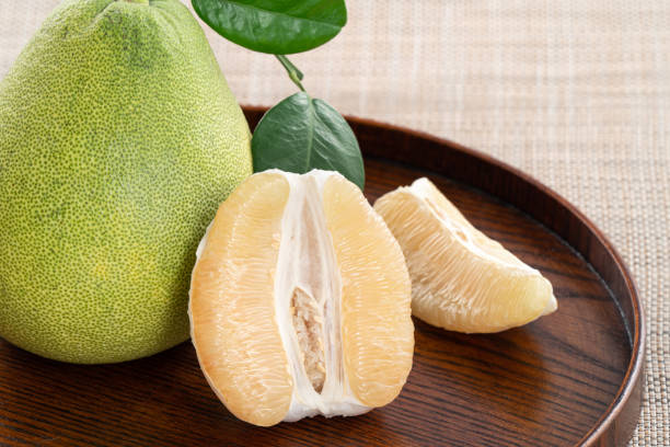 istock Fresh pomelo fruit on wooden table background. 1471999797