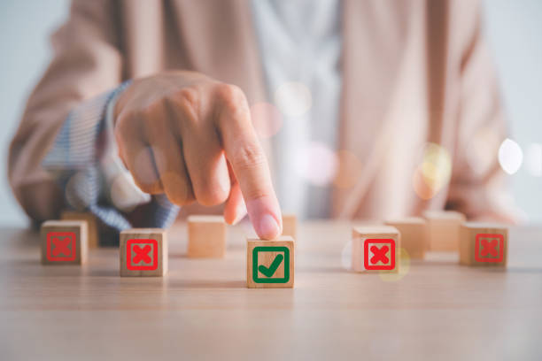woman hand on top wood cube stack with correct cube in hand , change from wrong to right