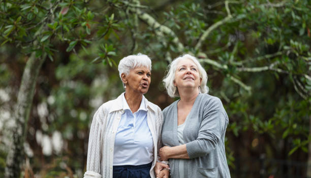 istock Senior women walking, talking in back yard 1472003249