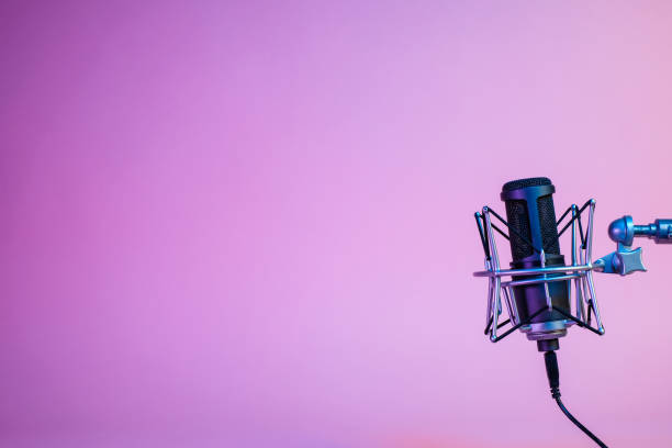 istock a black microphone on black background under the neon light. podcasting, singing, and recording background. 1472007948