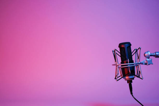 istock a black microphone on black background under the neon light. podcasting, singing, and recording background. 1472007952