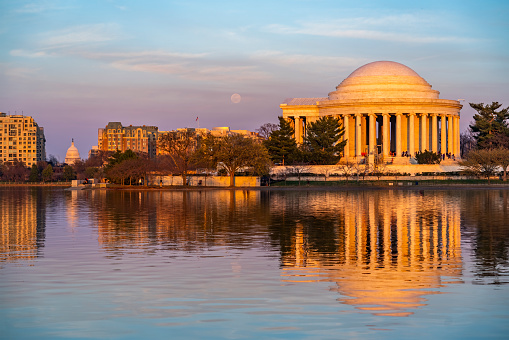 The Jefferson Memorial and Capitol Building in Washington DC at sunset.