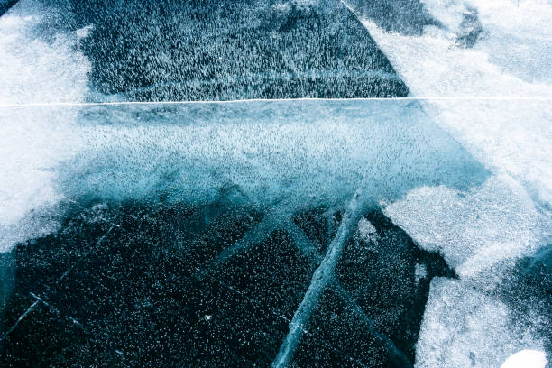 Cracked ice on a frozen lake, view from the top. Mouse background.