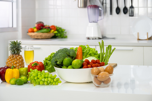 Healthy foods of fresh vegetables, fruits, eggs and pineapple juice on white table in home kitchen . Home healthy lifestyle concept