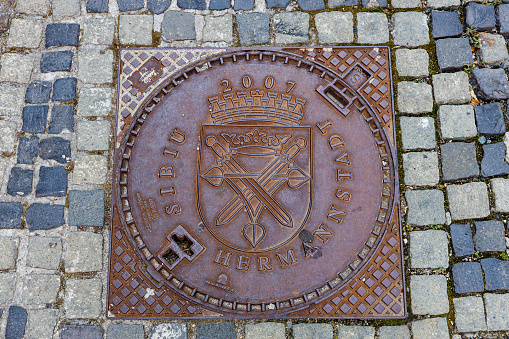Hermannstadt, Sibiu, Romania - August 08, 2021: Coat of Arms on a Manhole Cover in Sibiu Romania
