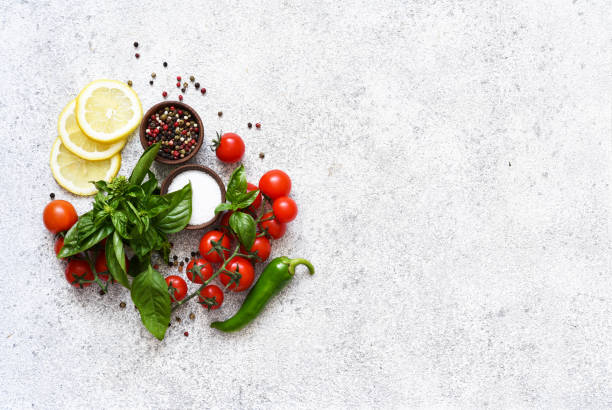 istock Pepper grinder, basil, cherry tomatoes on a white background with space for text. Food ingredients. 1472015782