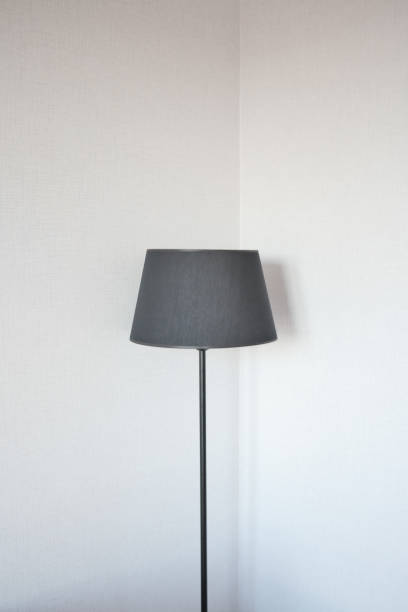 istock a lamp against white wall at home 1472019519