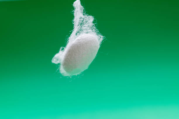 Close up of one silkworm coocoon on green background.