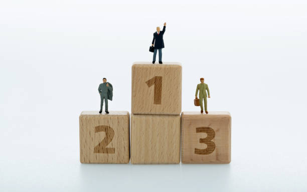 istock Podium with businessman figurines on white background 1472019942