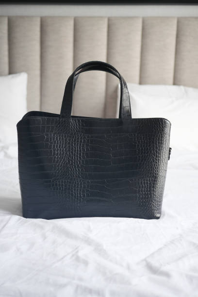 istock women purse wallet on bed, close up. 1472020499
