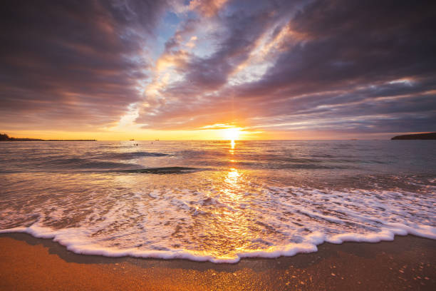 istock Beautiful sunrise over the sea waves and beach shore 1472021703