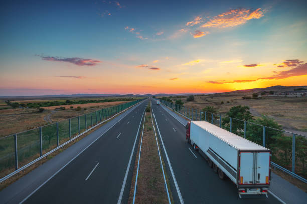 Driving on open road at beautiful sunset. Aerial view