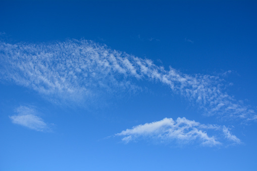 Blue sky with clouds at sunny day for backgrounds or textures.