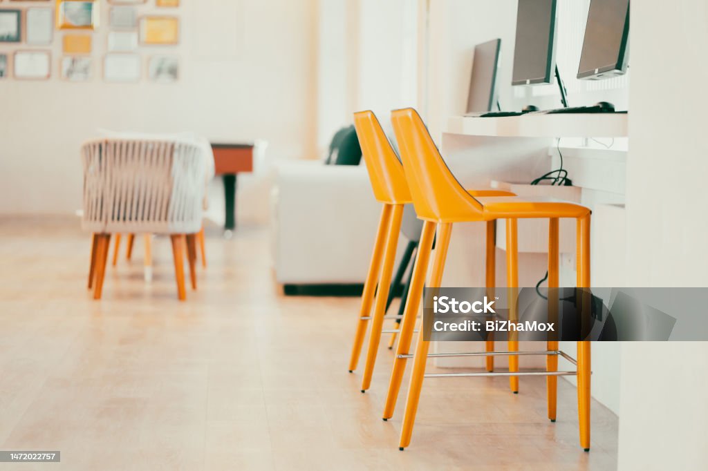 A bright yellow padded chair for typing in the computer in the internet room A bright yellow padded chair for typing in the computer in the internet room. Apartment Stock Photo