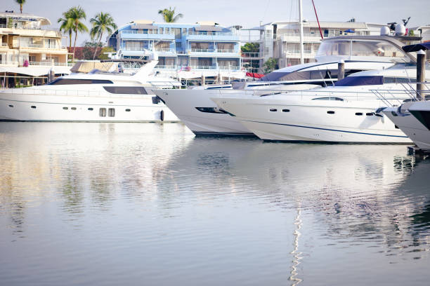 Gold Coast, Australia - October 16, 2014: People ride on a boat in front of Marina Mirage Shopping Center. It's Queensland's finest waterfront shopping and dining resort with award winning restaurants, designer boutiques of world's top fashion labels