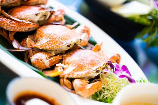 Steamed blue crabs, delicious Thai seafood dishes are on a white plate ready to be served.