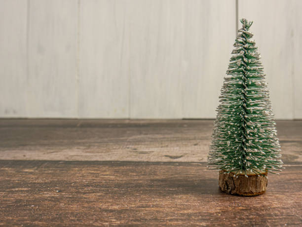 istock Christmas tree miniature on wood table for holiday concept 1472026280
