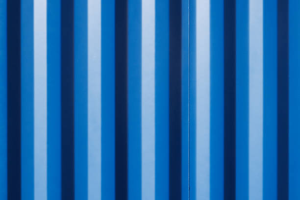 Close-up on part of a blue patterned metal fence.