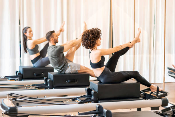 istock Class of group stretching legs on pilates reformer 1472027829