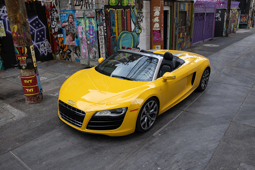 June 26, 2022 - Las Vegas, United States: An Audi R8 convertible in bright yellow parked in a graffiti covered alley in Downtown Las Vegas, NV.