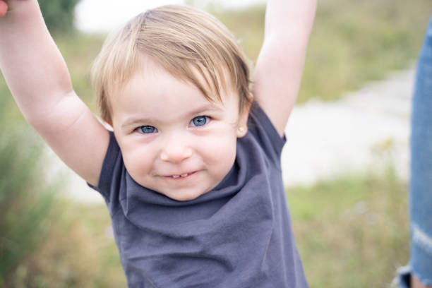 Close up portrait of a playful cute little girl smiling at camera