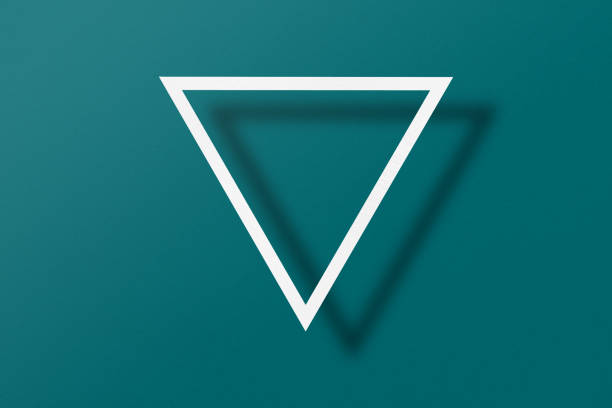 White paper cut into triangle shape, play button set on green paper background.
