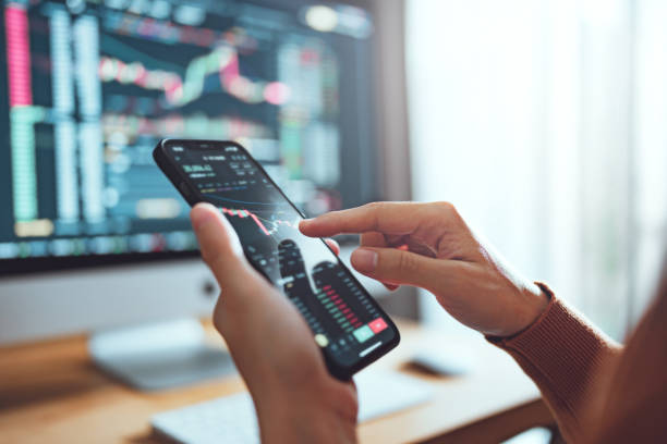 woman is checking bitcoin price chart on digital exchange on smartphone, cryptocurrency future price action prediction. - candlestick holder fotos imagens e fotografias de stock