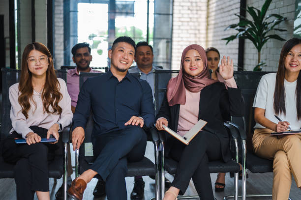istock Finding Common Ground: A Multiracial Business Seminar's Question Time in a Modern Office 1472030797