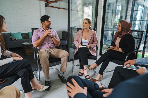 A multiracial group of businesspeople having a seminar in a modern office