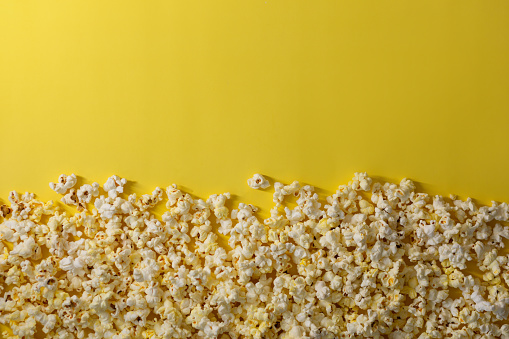Popcorn texture on a yellow background.