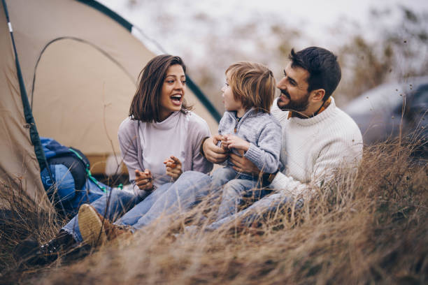 istock Happy family talking during camping day in autumn. 1472034452